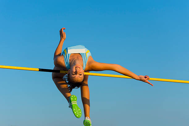 istock Young woman jumping over the lath during competition 165889813