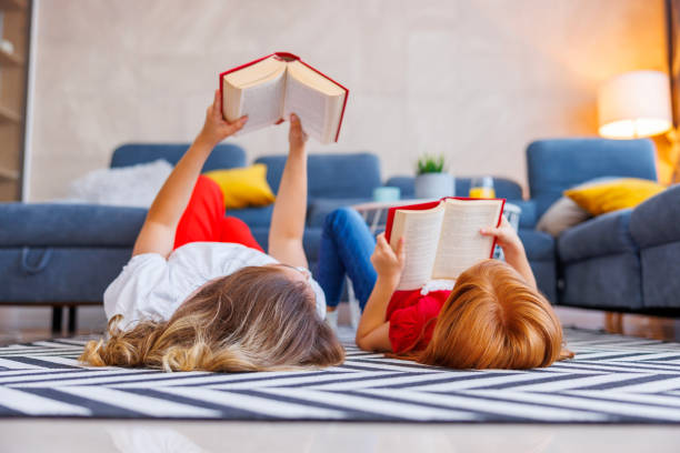 istock Mother and daughter reading books 1658900401