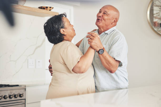 istock Happy, holding hands or old couple dancing in home kitchen for love, care or support while bonding together. Smile, elderly man or senior woman in celebration for anniversary or romance in retirement 1658905214