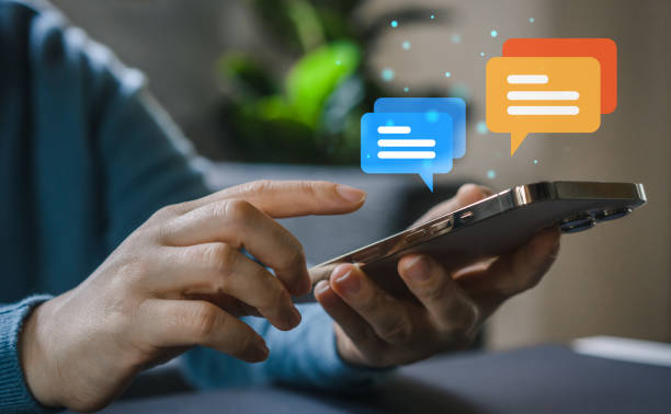 istock Human hand using smartphone typing Live chat chatting and social network concepts, chatting conversation working at home in chat box icons pop up. Social media marketing technology concept 1658931406