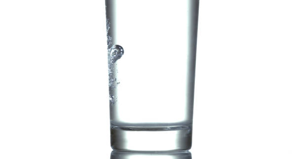 istock Water being poured into Glass against White Background 1658934212