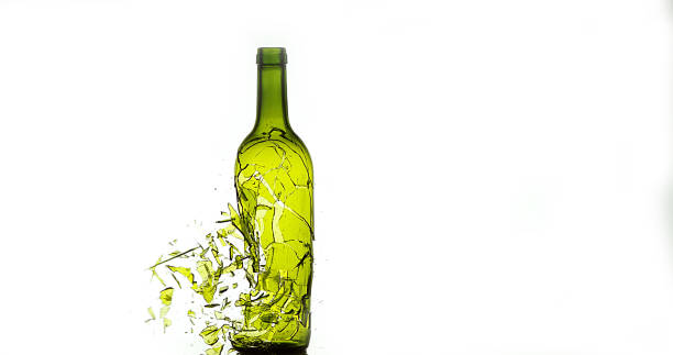 istock Bottle of White Wine Breaking and Splashing against White Background 1658939406