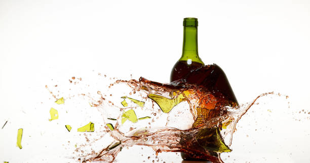 istock Bottle of Red Wine Breaking and Splashing against White Background 1658960115
