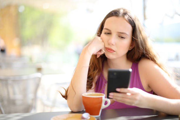 istock Frustrated woman checking phone in a restaurant 1658963540