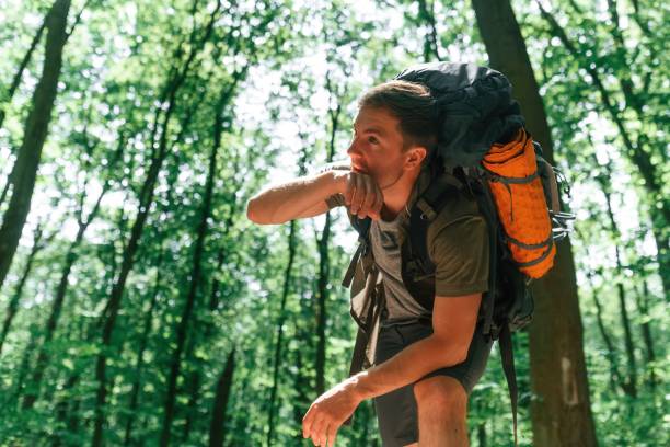 istock Tired, taking a break. Tourist in summer forest. Conception of exploration and leisure 1658972098