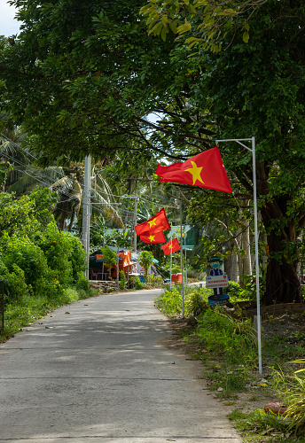 The road on Ha Tien island is hung with the Vietnamese flag, Kien Giang province