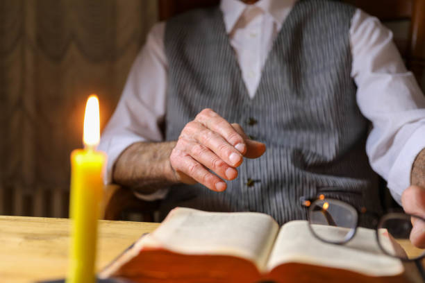 istock a man reads the bible by candlelight 1658985329