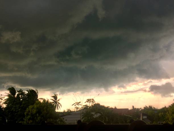 istock Dark clouds formed in the sky. It symbolizes an approaching rainstorm and sunlight shining through 1658992112