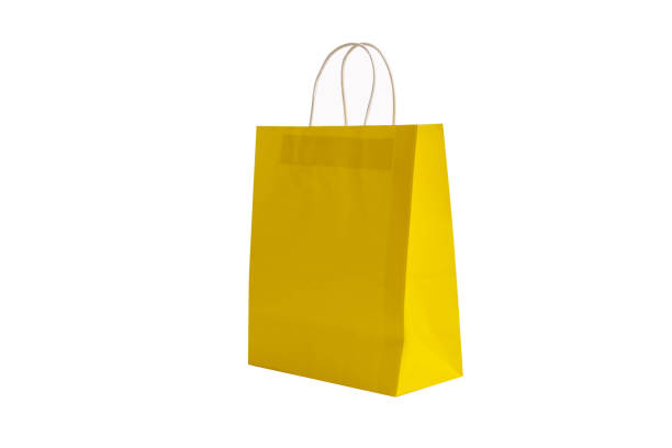 istock Yellow paper bag laying on a white background. 1659006719