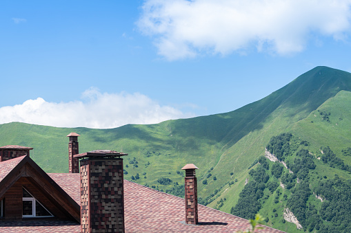 Roof of a ski resort in Gudauri city of Georgia and Beautiful green Caucasian mountain landscape