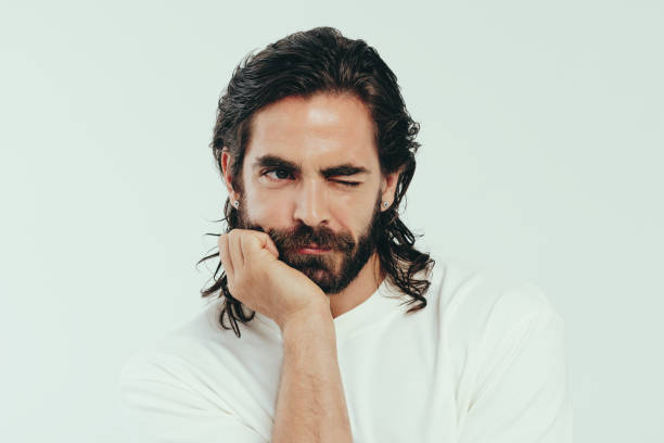 istock Lifestyle of grooming: Handsome young man winks in a studio 1659035752
