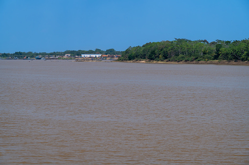 Beautiful Amazon rainforest landscape view of Mamoré river in the border of Brazil and Bolivia, Guajará-Mirim city on a sunny summer day. Concept of environment, ecology, nature, climate change.