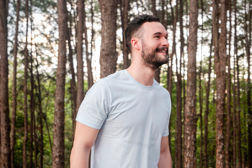 Photo of a man exercising in a natural parkland.