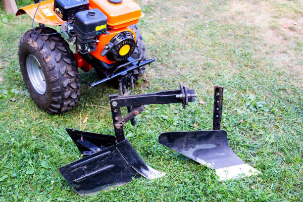 Plow and hiller complete with a walk-behind tractor for agricultural work. Motor cultivator