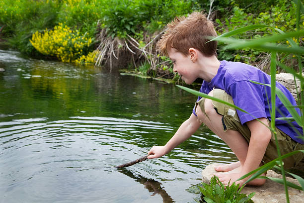 girl puts her foot in a lake, a wellness vacation at hot springs