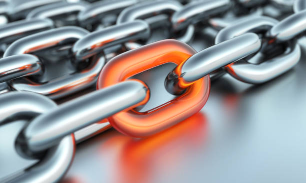 Orange glass link with silver chains. Leadership concept