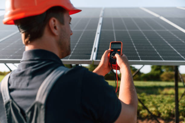 istock Measuring the electricity by using device. Man is doing operating and maintenance in solar power plant 1659047176