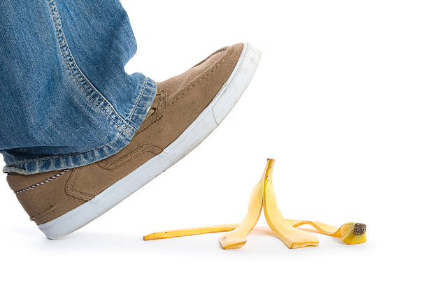 step on banana peel man's foot about to slip on banana peel slapstick comedy stock pictures, royalty-free photos & images