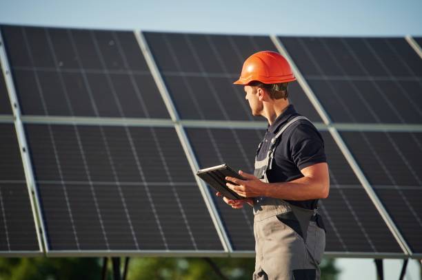 istock Tablet in hands. Man is doing operating and maintenance in solar power plant 1659049308