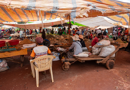Accra, Ghana - 5 Februar 2022:  african market woman sells vegetables under a sunshade at a market in Accra