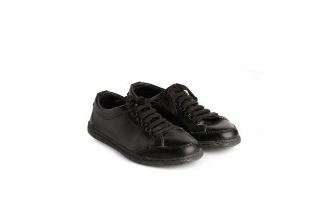 istock A pair of black leather sneakers on a white background 1659056232