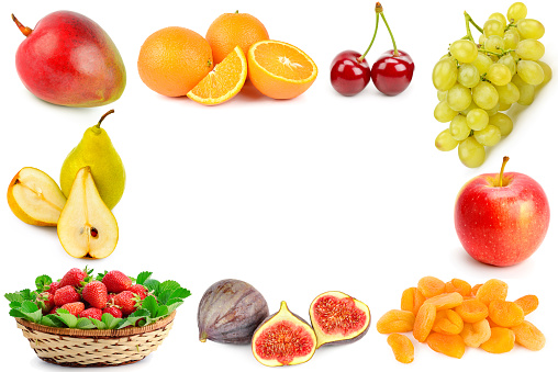 Close up of variety of asian fruits in basket on white background