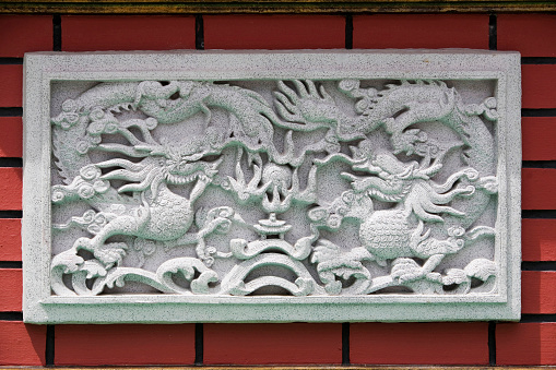 stone carving of dragon on the wall.
