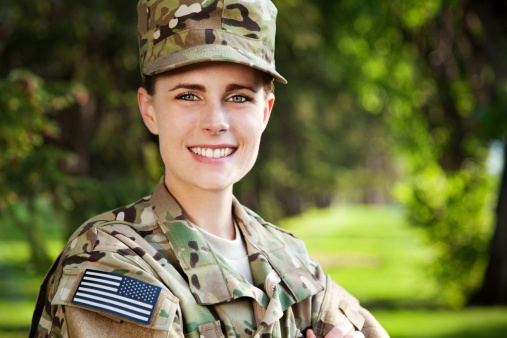 Female American soldier in new army multicam uniform or ACU smiling. 