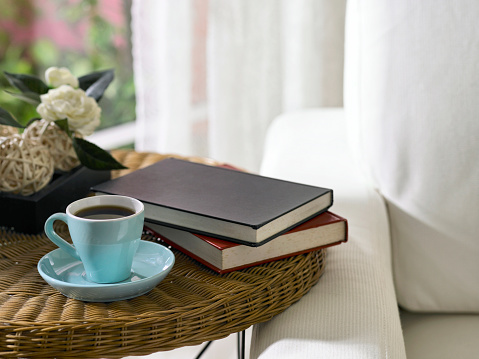 tea cup and books on a table.