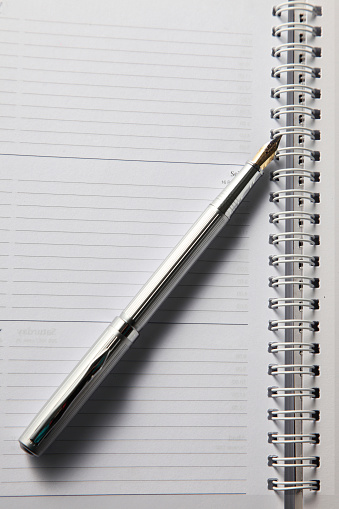 Close up of pen and blank organizer