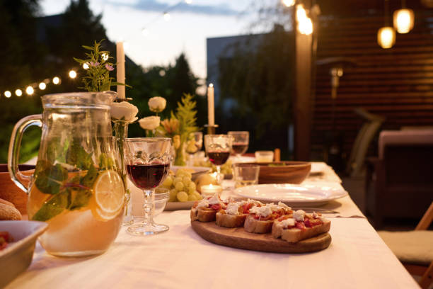 istock Focus on part of table served with jug with lemonade and some snacks 1659098728