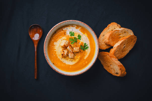 istock Pumpkin soup with cream on black background 1659128846