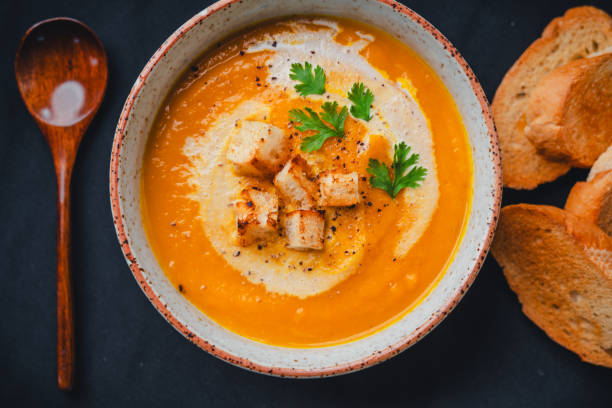 istock Pumpkin soup with cream on black background 1659128863