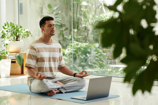 istock Young serene man in activewear keeping eyes closed during yoga practice 1659129709