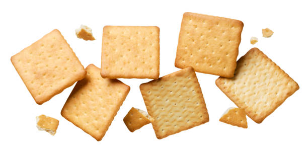 istock Crackers cookies with pieces are flying on a white. Isolated 1659129906