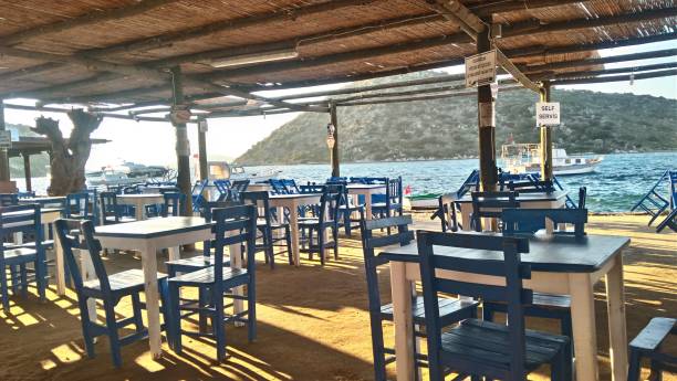 istock Seaside tea garden with blue chairs and tables. 1659131411
