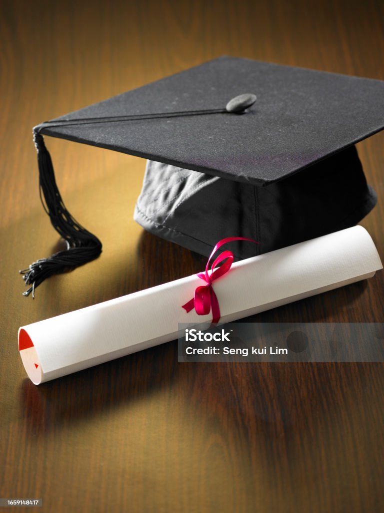 Graduation cap and diploma close up  of Graduation cap and diploma Achievement Stock Photo
