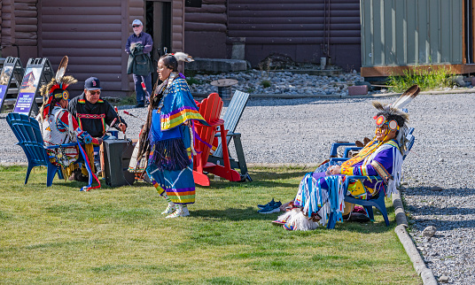 Banff National Park, Alberta, Canada – August 26, 2023:  An aboriginal dancer performs to the music of drummers at Sunshine Village