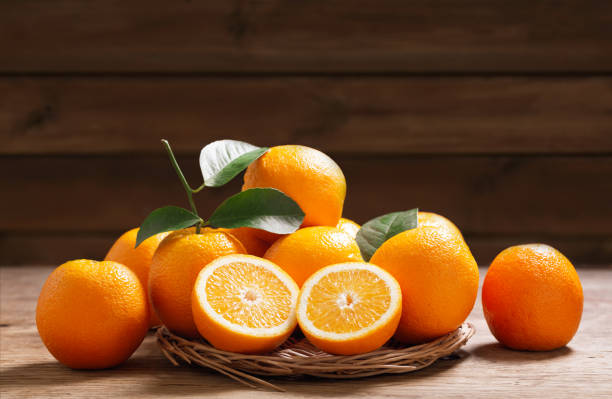 istock fresh orange fruits with leaves 1659162340