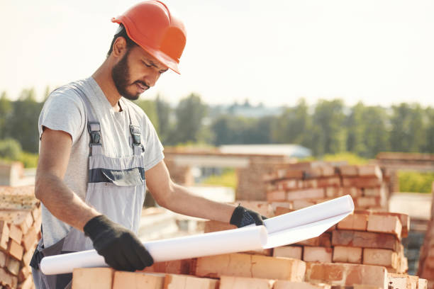 istock Reading the plan that is in the hands. Handsome Indian man is on the construction site 1659180281