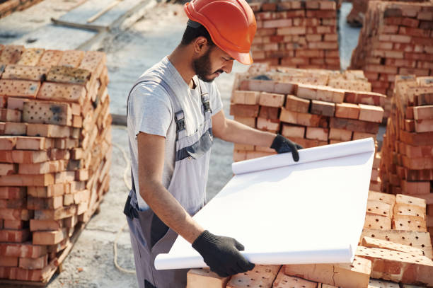 istock Reading the plan that is in the hands. Handsome Indian man is on the construction site 1659182482