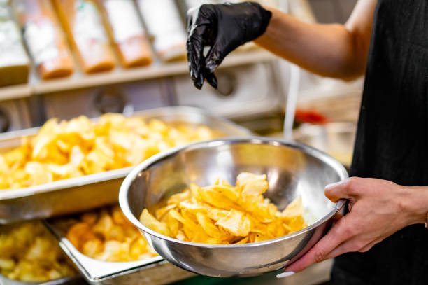 istock woman chef preparing potato chips in kitchen 1659184706