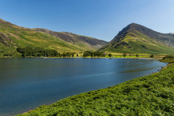 istock A beautiful, calm lake surrounded by high mountains in summer (Buttermere, Lake District) 1659186957