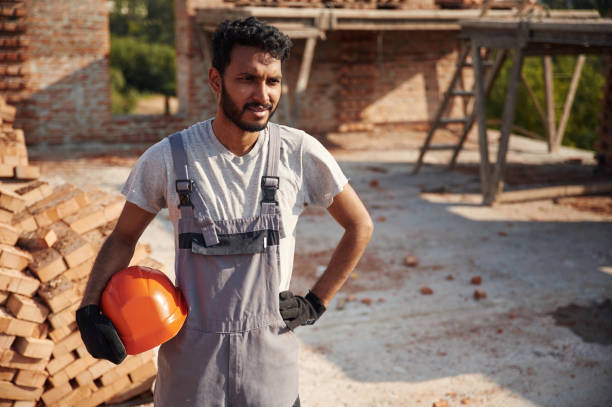 istock In grey uniform. Handsome Indian man is on the construction site 1659197528