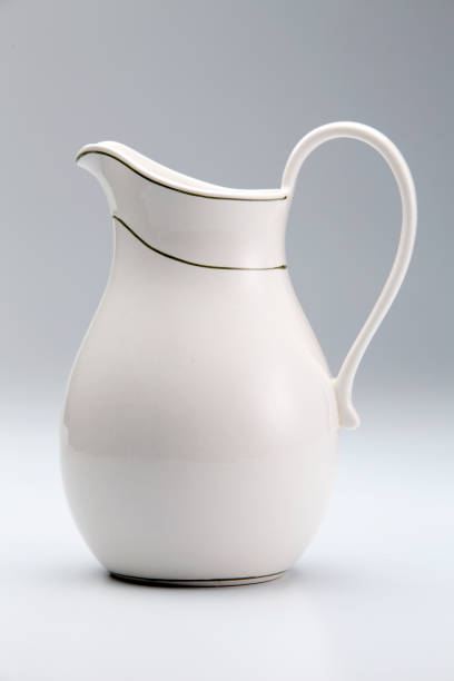 white milk jug or pitcher against white background