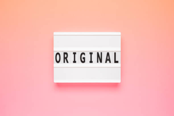 istock The word original on lightbox isolated pink background. Info concept 1659206899