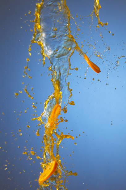 the orange juice splash against blue background