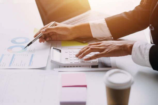 istock Financial analysts analyze business financial reports on a digital tablet planning investment project during a discussion at a meeting of corporate showing the results of their successful teamwork. 1659220552