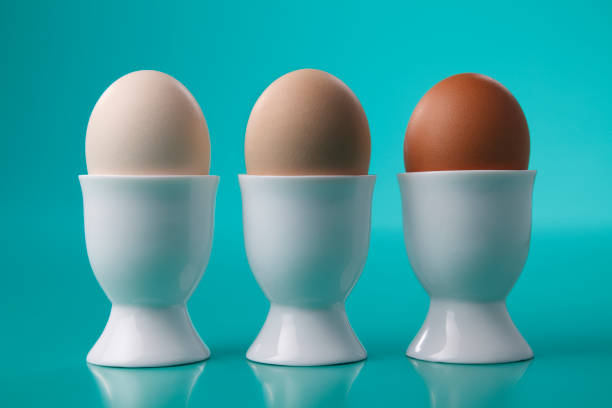 istock Three different color of  eggs in porcelain egg cups. 1659222257
