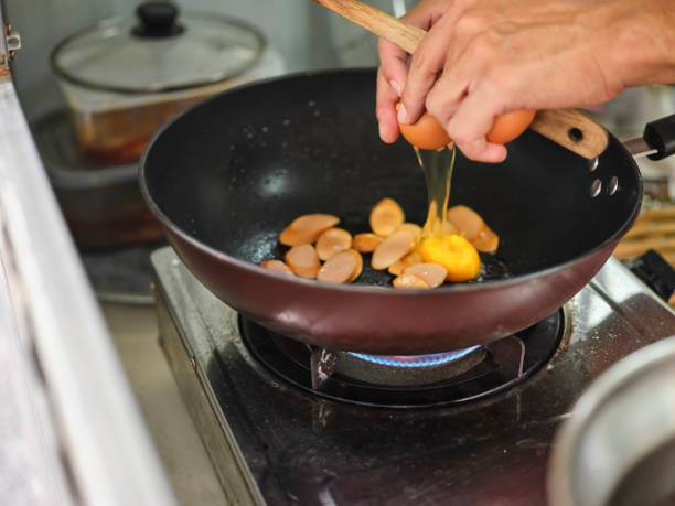istock Cooking of sausage fried rice and crack an egg 1659224513
